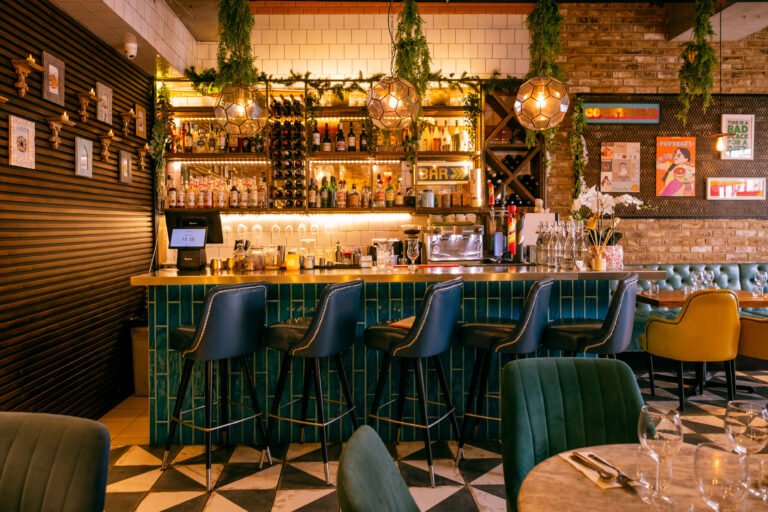 The bar at Chit Chaat with blue tiles and pendant lights