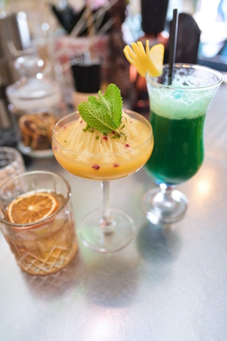 Four cocktails lined up on the bar