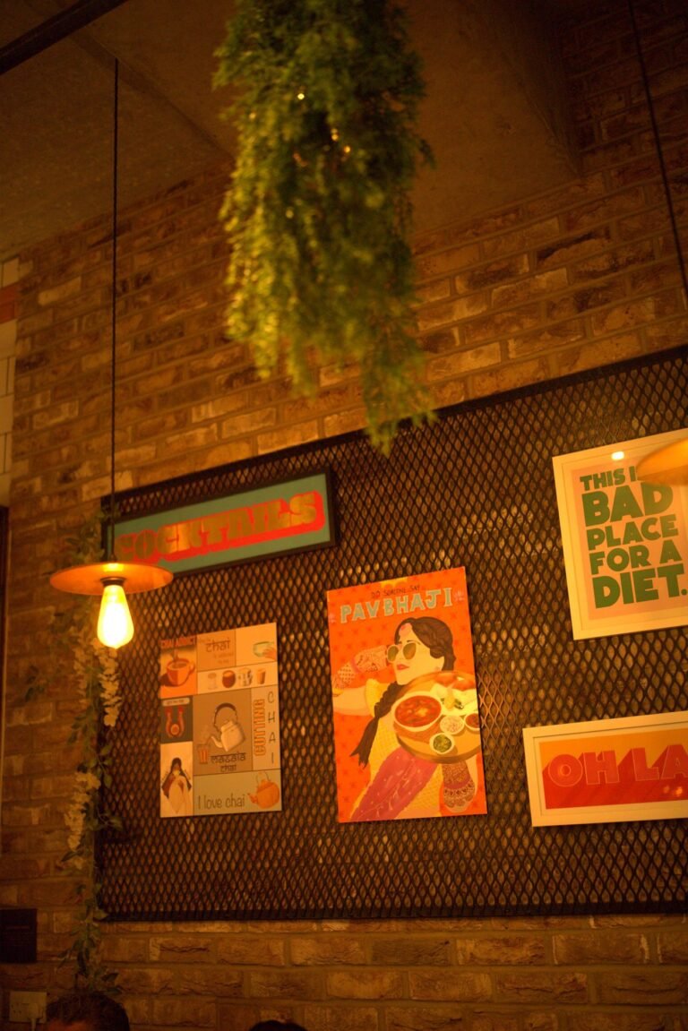 The poster wall at Chit Chaat with retro Indian prints